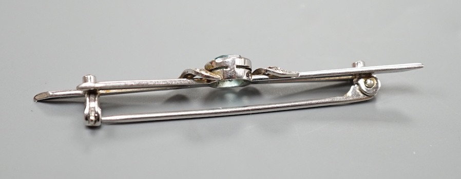 A 14ct white gold, blue zircon and diamond chip set bar brooch